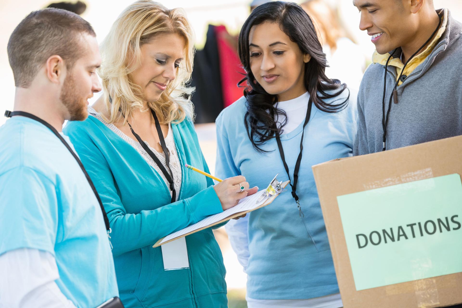 Charity director signing up volunteers at donation drive